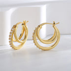 gold plated triple hoop clear stone earrings in an upright studio view