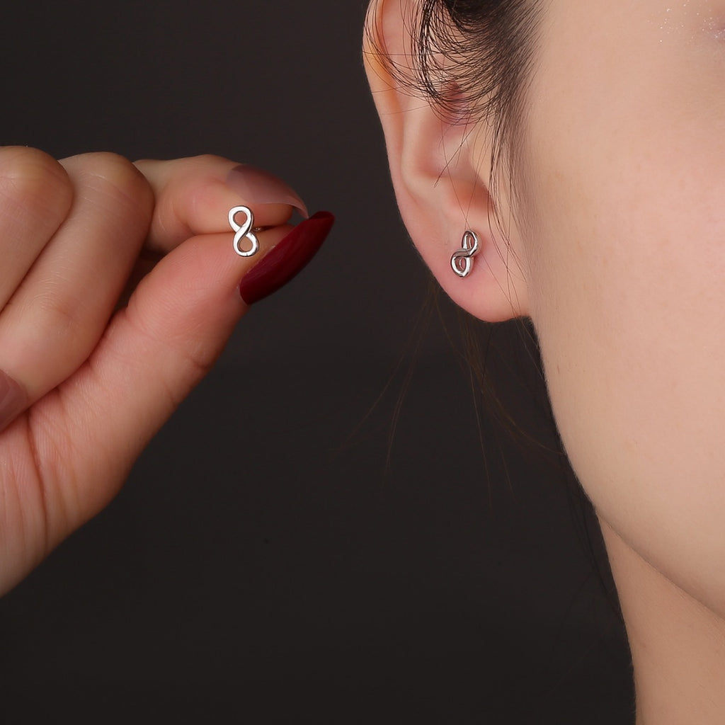 model wearing a petite silver infinity stud earring