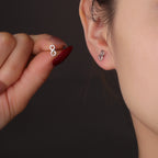 model wearing a petite silver infinity stud earring