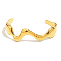 gold plated polished wave open cuff isolated on white