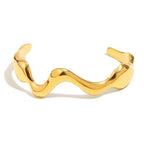 gold plated polished wave open cuff isolated on white