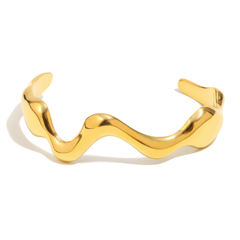 gold plated polished wave open cuff isolated on white