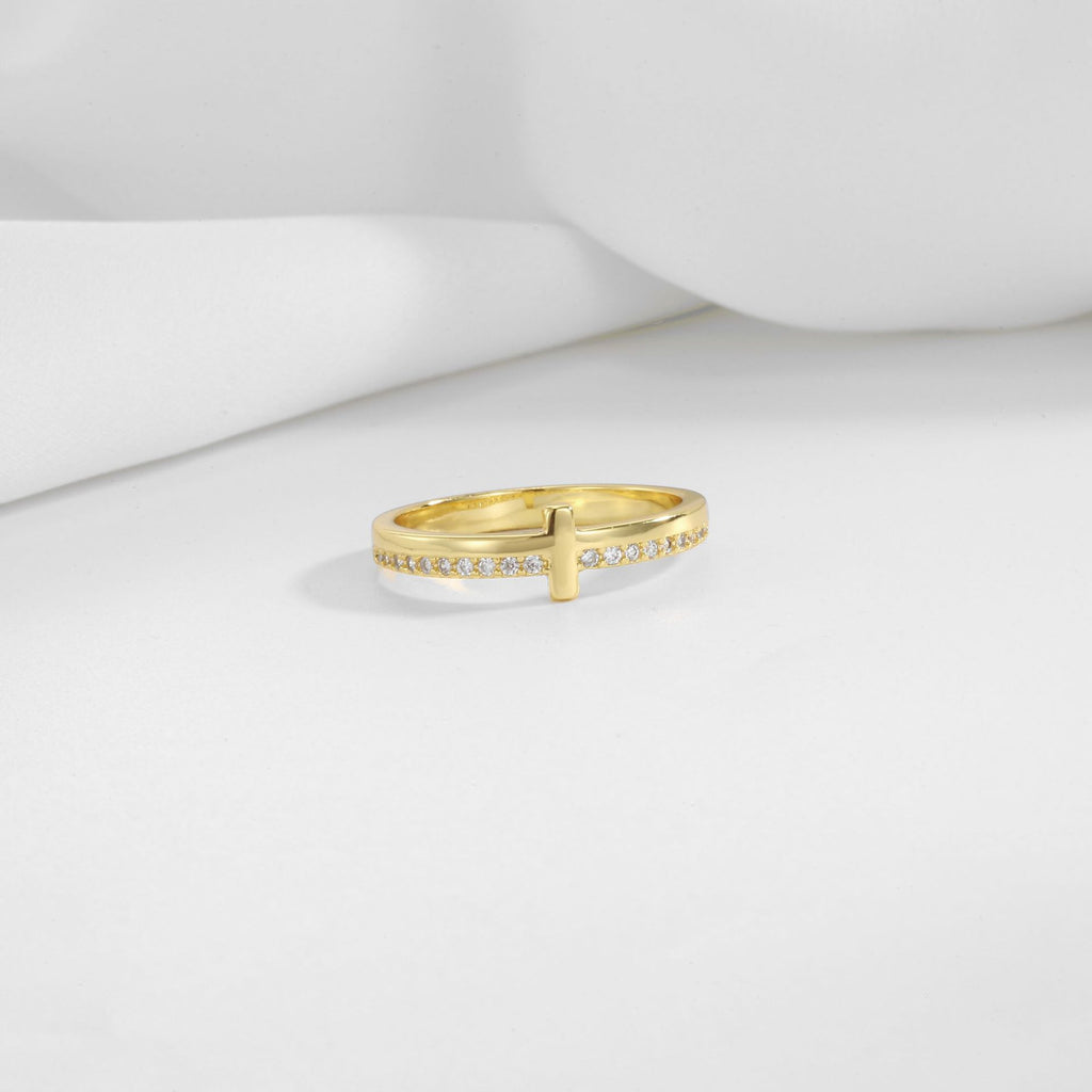 gold plated brass cross ring displayed on white folds