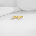 gold plated brass cross ring displayed on white folds