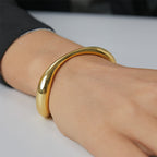 close-up of polished wave bangle on wrist