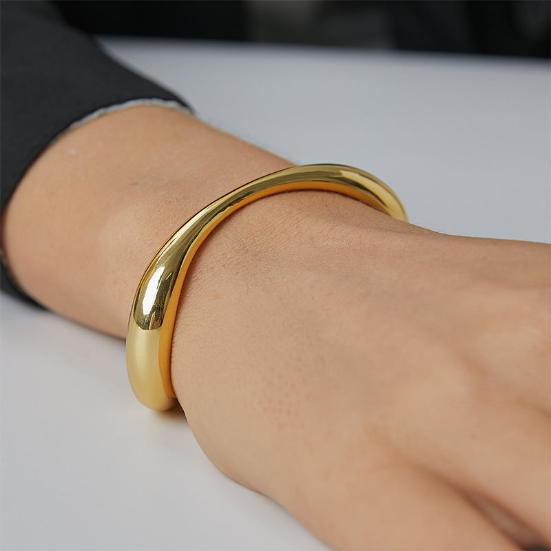 close-up of polished wave bangle on wrist