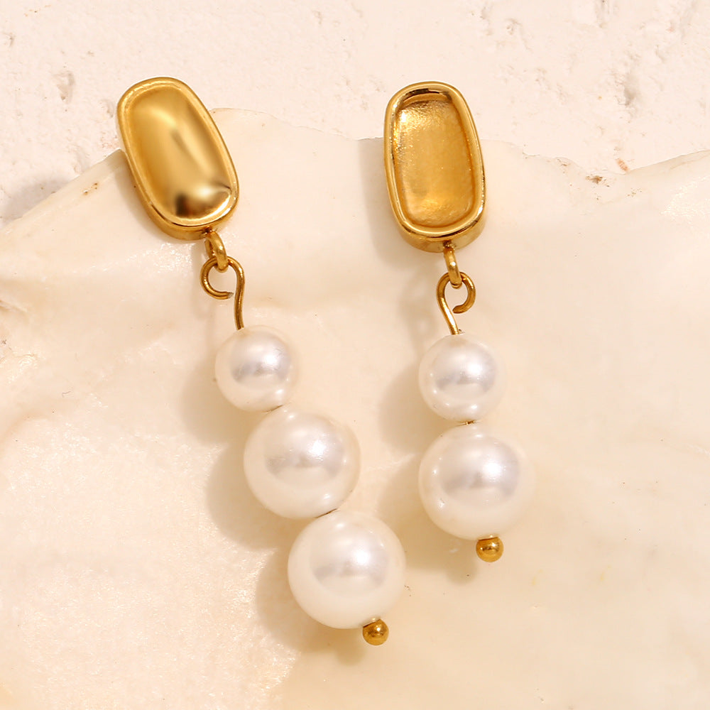 front and back view of mismatched pearl drop earrings