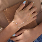 Irregular white pearl stainless steel hand chain shown on a wrist
