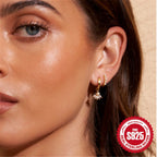 model wearing small 925 silver pearl and clear-stone drop hoops