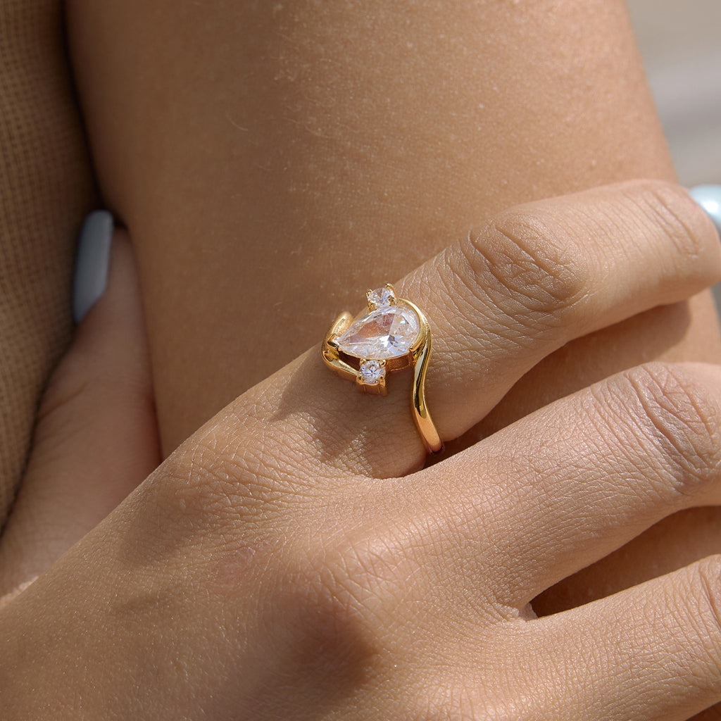 Side view of gold-tone bypass ring worn close-up