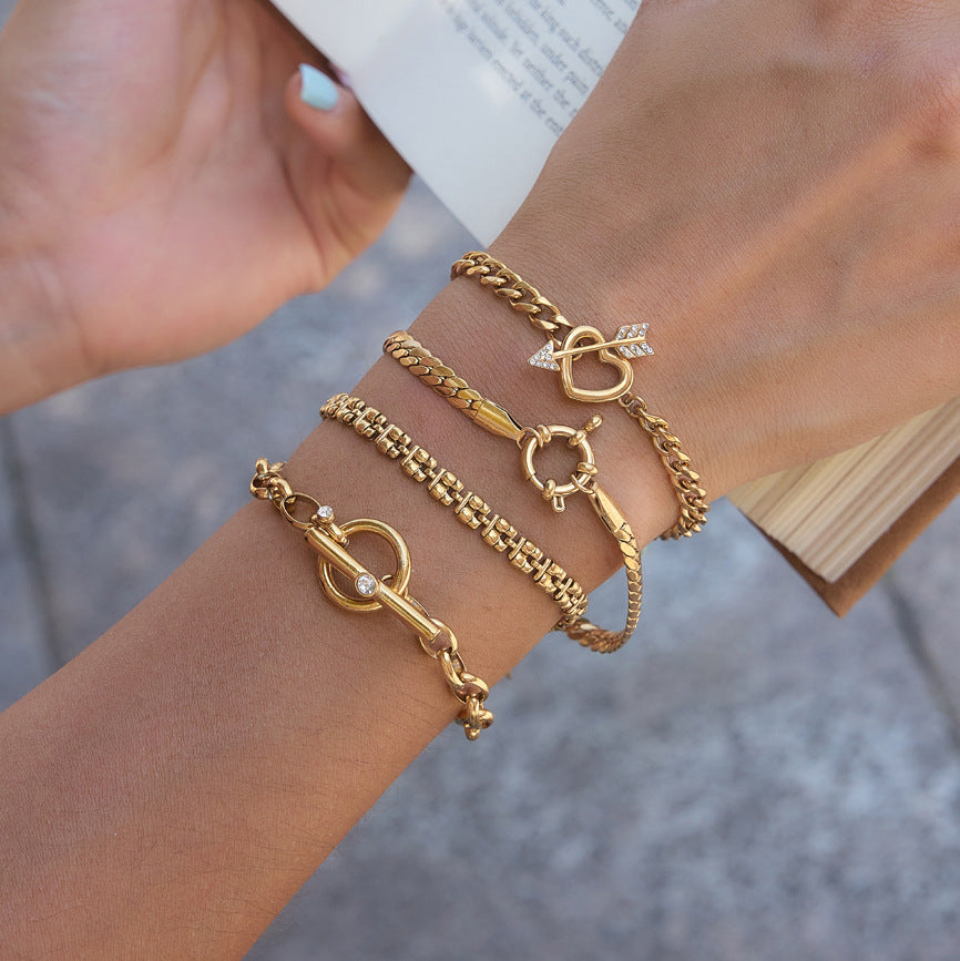 Heart and circular fastenings on layered bracelets