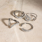 Silver-tone clear-accent rings arranged on stone
