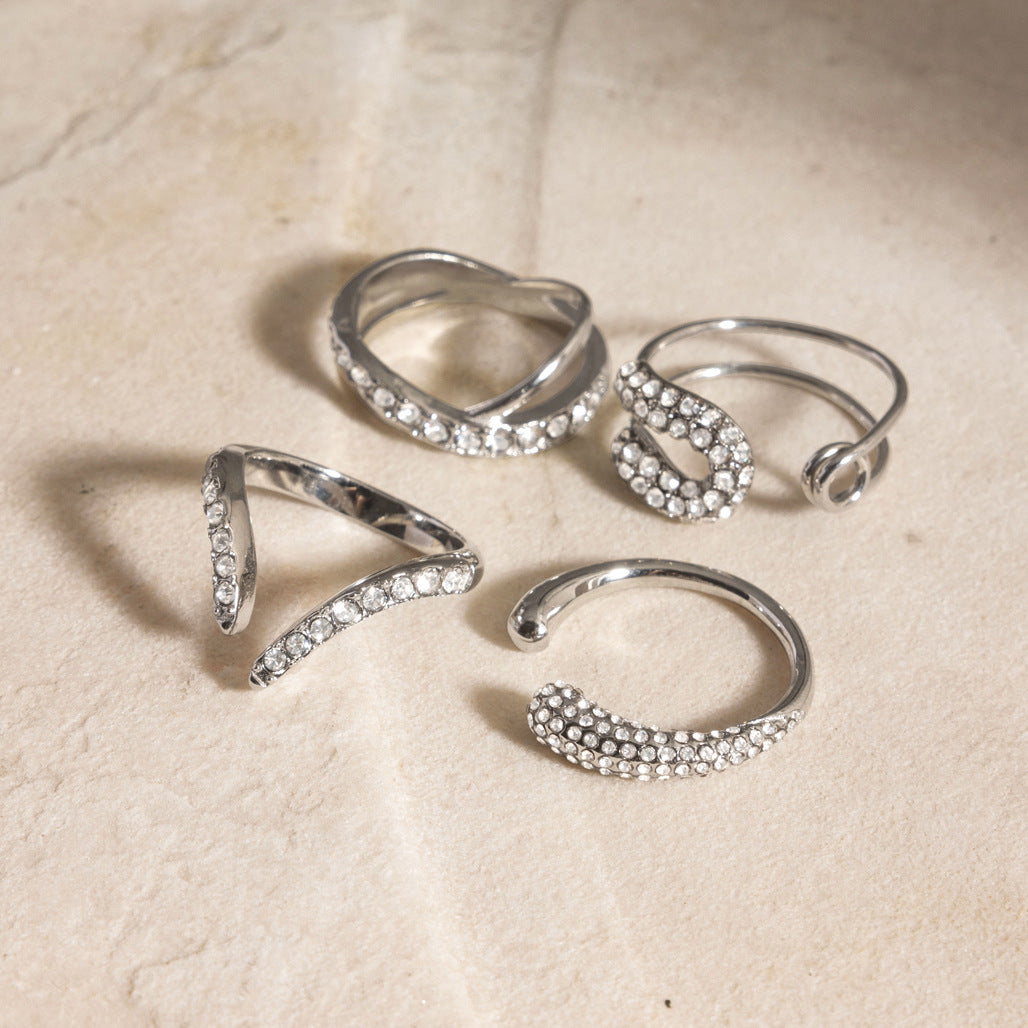 Silver-tone clear-accent rings arranged on stone