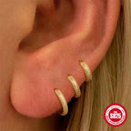 6 mm, 8 mm and 10 mm textured gold huggies worn as an ear stack