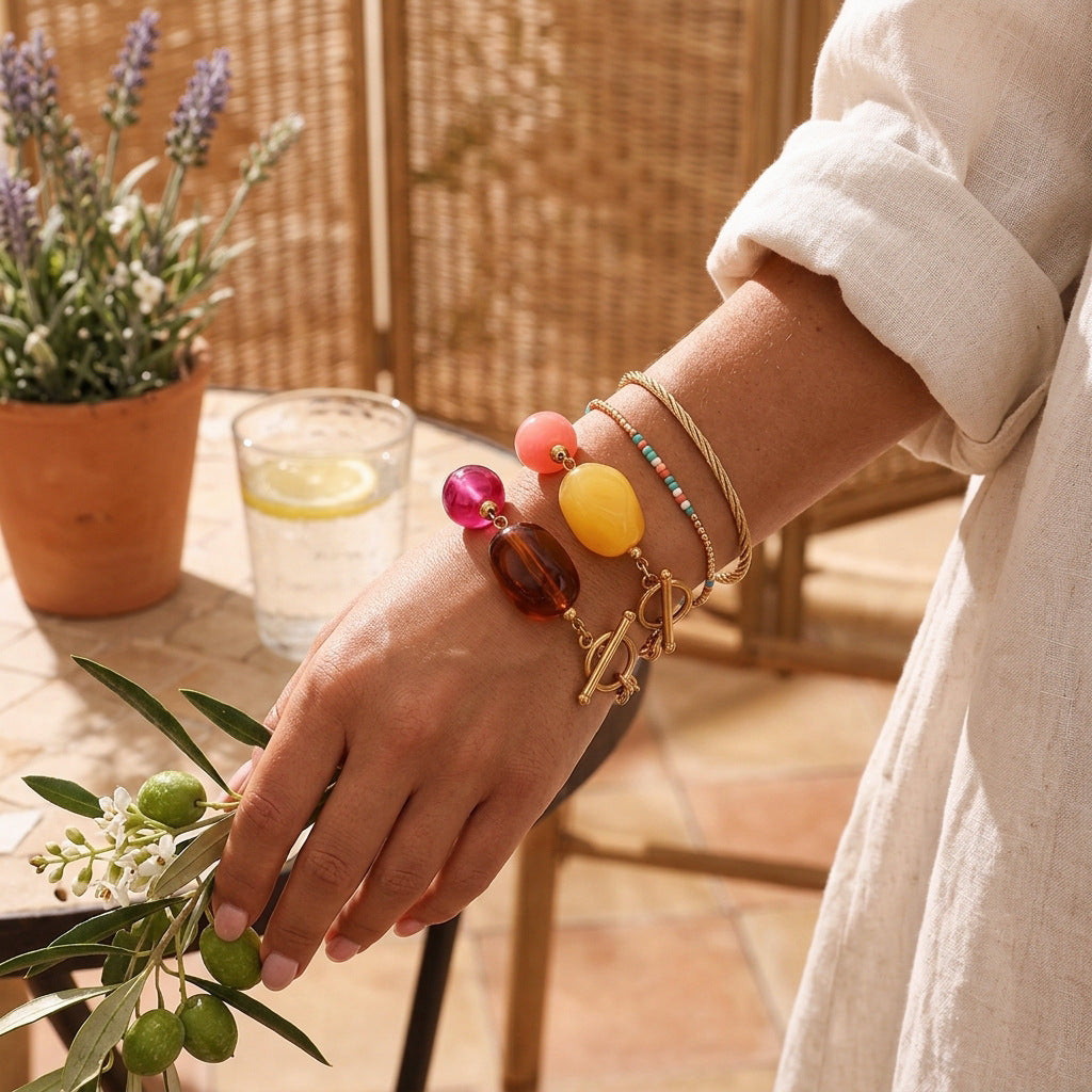 Two bold resin bracelets worn with separate fine wrist jewelry