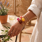 Two bold resin bracelets worn with separate fine wrist jewelry