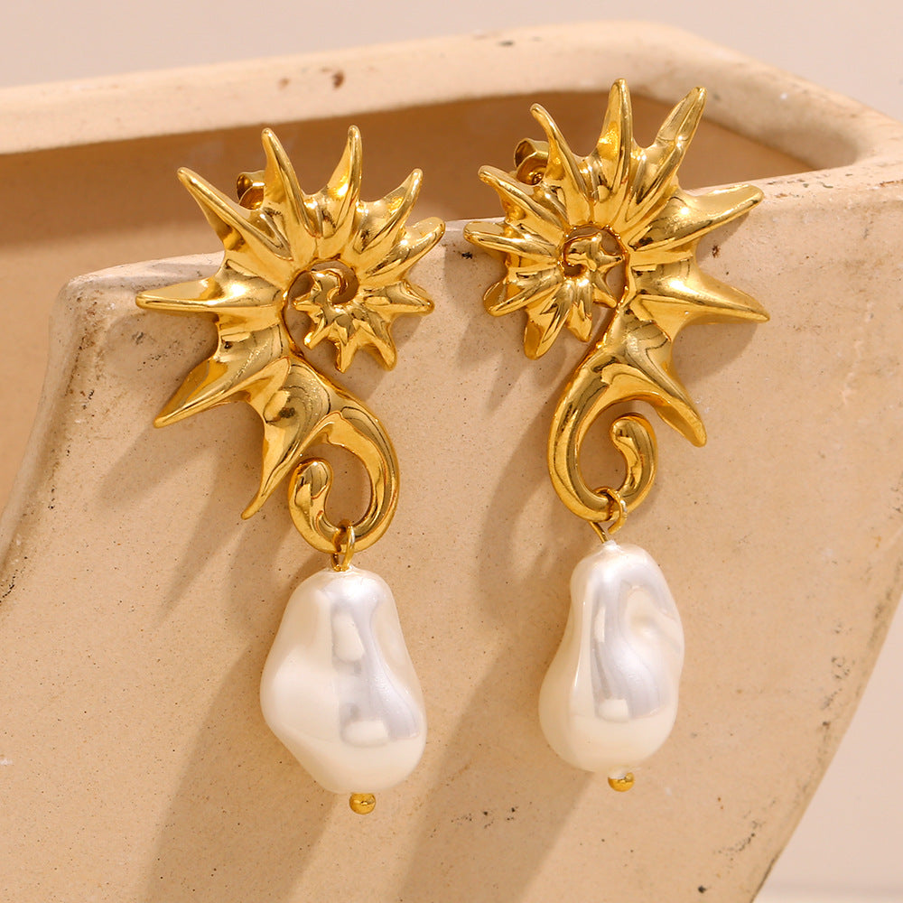gold plated seahorse earrings with irregular white pearl drops on stone