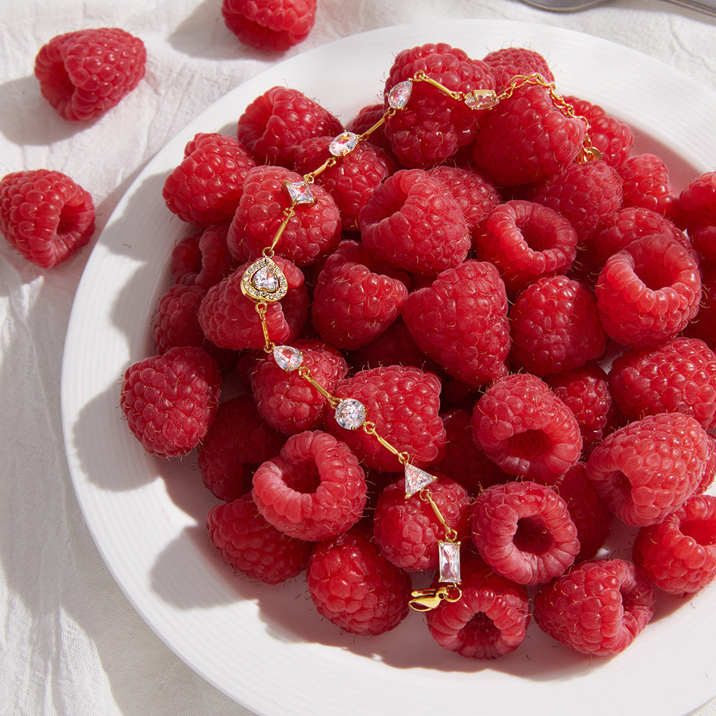 Heart centerpiece bracelet beside raspberries