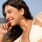 Heart drop earrings shown on model