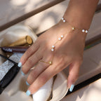 Pearl hand chain with starburst connector worn on a model
