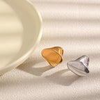Two polished oval rings beside a pale dish