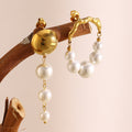 mismatched gold plated faux pearl drop earrings styled on a branch