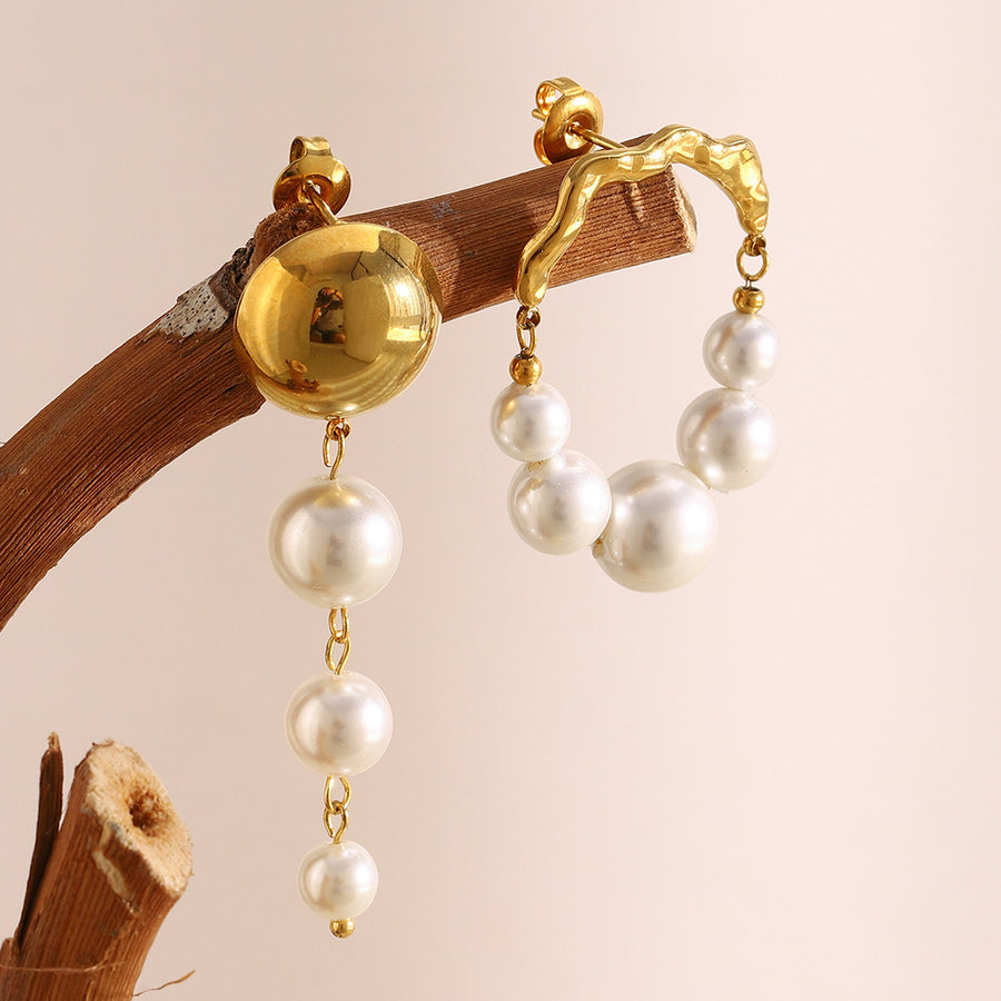 mismatched gold plated faux pearl drop earrings styled on a branch