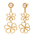 gold plated double flower earrings with round white bead accents on white