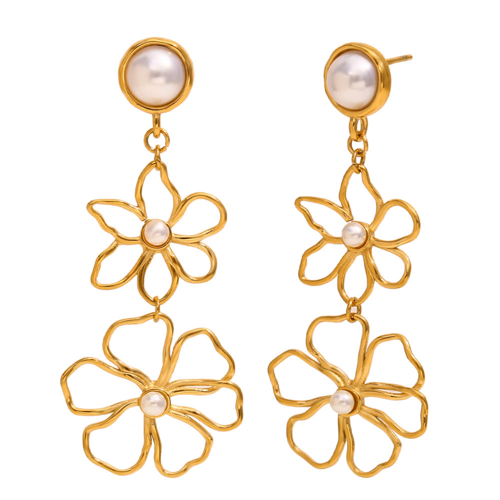 gold plated double flower earrings with round white bead accents on white