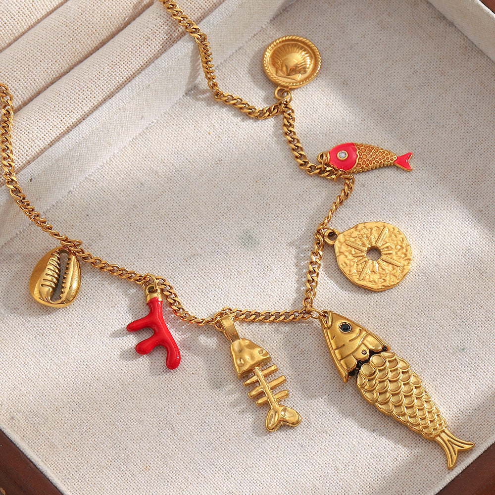 Gold plated fish, coral, shell and sand dollar charm necklace