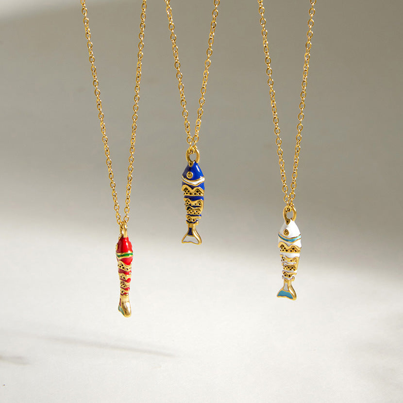 Gold finish fish necklaces hanging in three color options