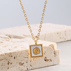 angled rose medallion pendant displayed on pale stone