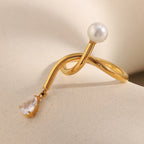 side view of asymmetrical knotted open ring with clear stone drop