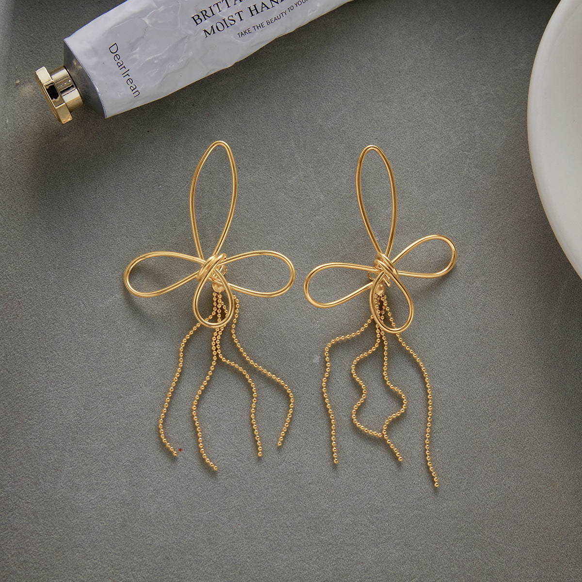 Butterfly Fringe and Star Drop Stainless Steel Earrings — styled view of the butterfly pair