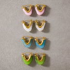 Four resin U-shaped hoop colorways arranged together