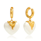 front and side view of the ivory pearlized resin heart earrings