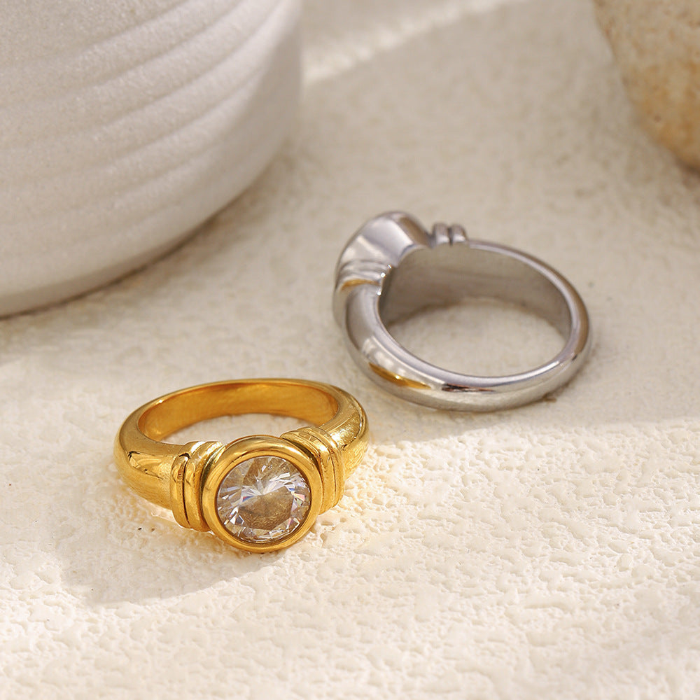 back view of gold plated and silver-finish round-stone rings