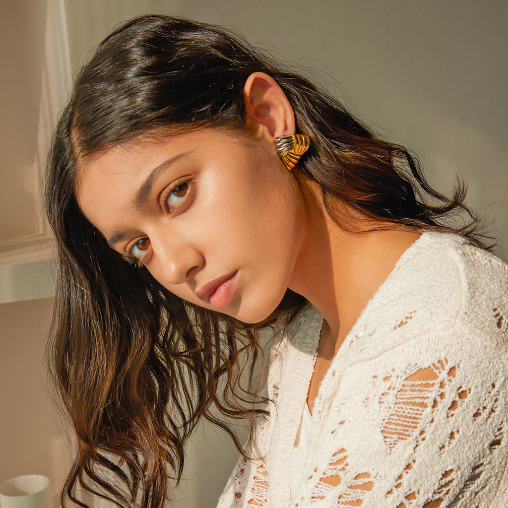 Two-Tone Textured Triangle Stainless Steel Stud Earrings shown on model