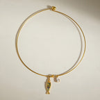 Gold-tone collar with multicolor inlay fish charm and clear drop
