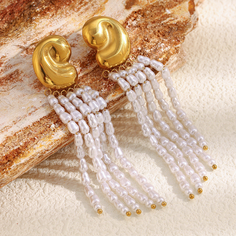 gold plated sculptural stud and pearl tassel earrings on stone