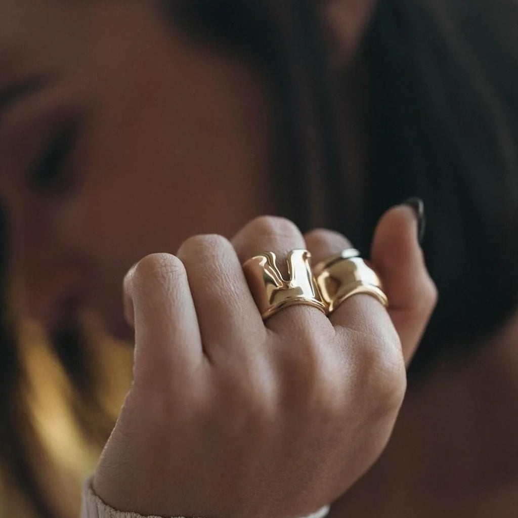 gold plated sculpted wave open ring worn on hand