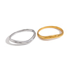 Gold and silver tone bangle profiles on white