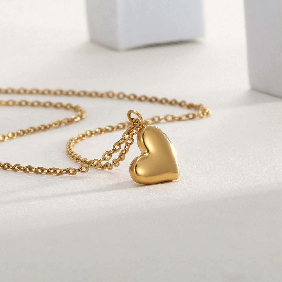 asymmetrical heart pendant displayed with its fine cable chain
