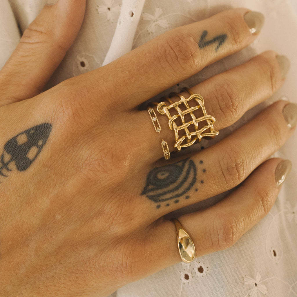 Open lattice stainless steel ring worn on a hand