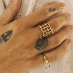 Open lattice stainless steel ring worn on a hand