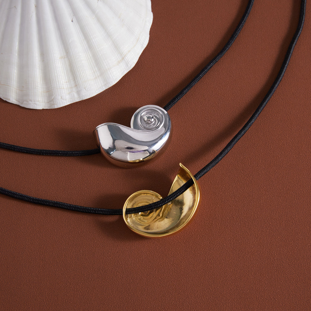 Silver pendant front and gold pendant reverse views