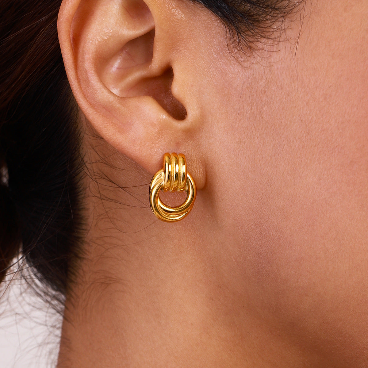 Stainless Steel Interlocking Loop Stud Earrings in Two Finishes on-model view