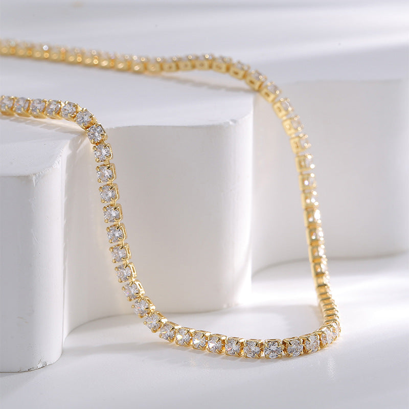 close-up of continuous clear stone settings on gold plated anklet