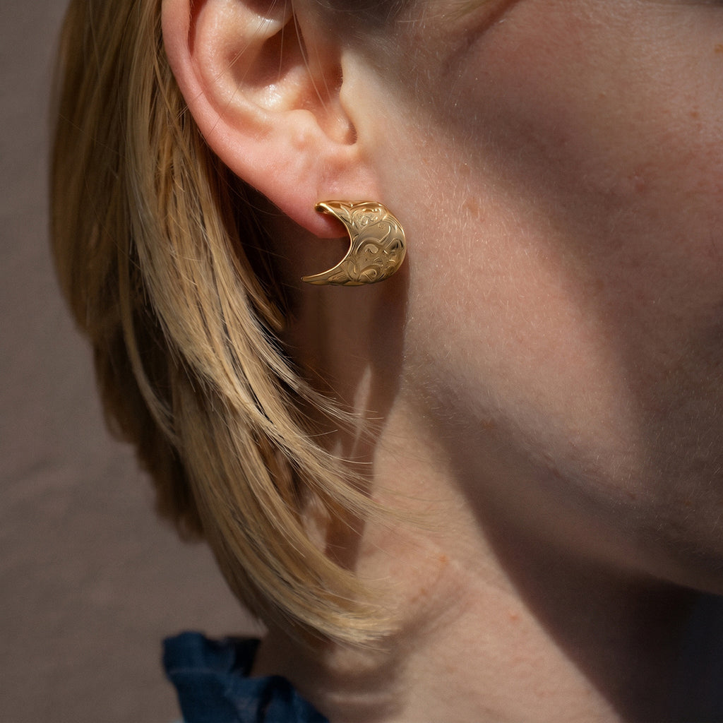 Short flared scroll earring worn on the ear
