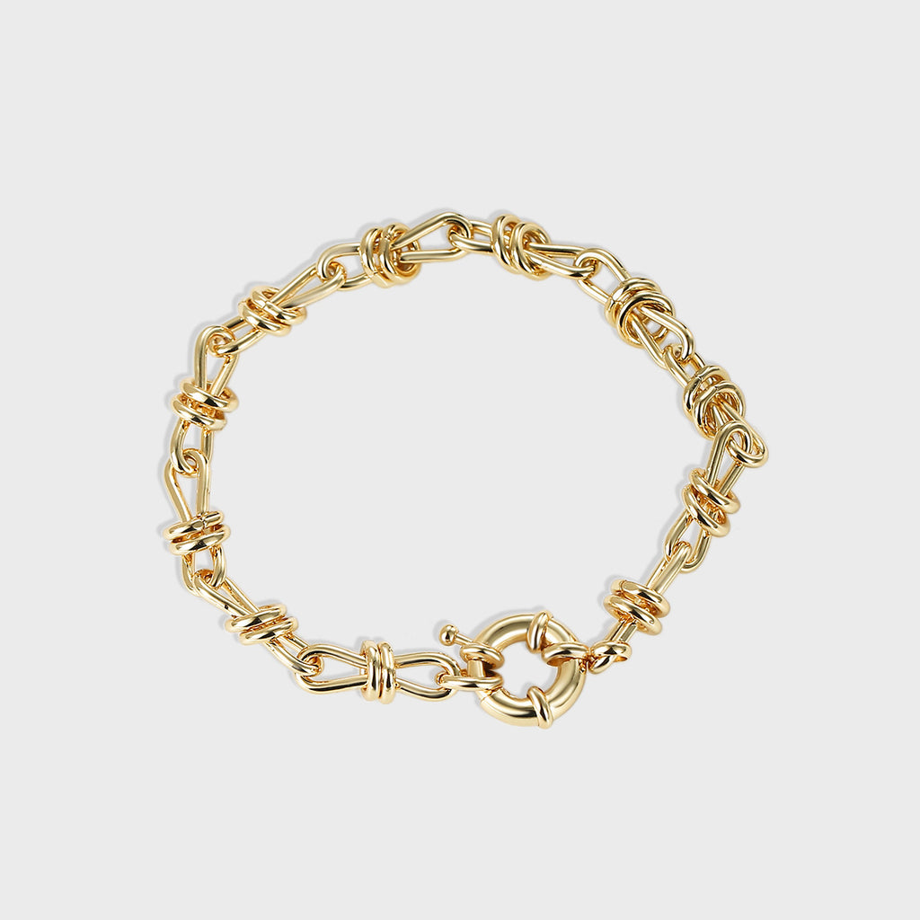 isolated gold plated brass chain bracelet with bow-knot link wraps